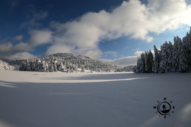 Frozen Lake Dasiou under a clear winter sky