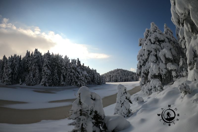 Panoramic view of snow-covered Lake Dasiou