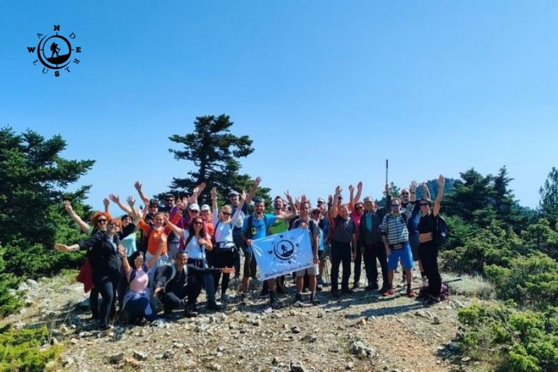 Group photo of hikers in a clearing on Mount Parnitha