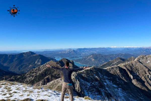 Hiker on the summit of Mount Chelidona overlooking the mountains of Evrytania